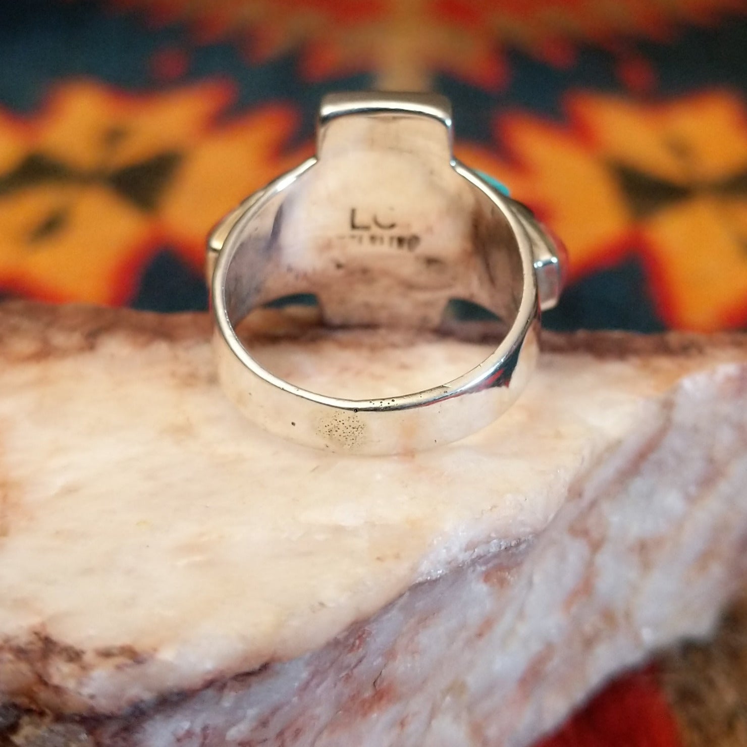 Chunky sterling silver ring featuring multi-stone inlays.