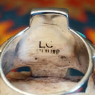 Close-up of the artisan's stamped signature.