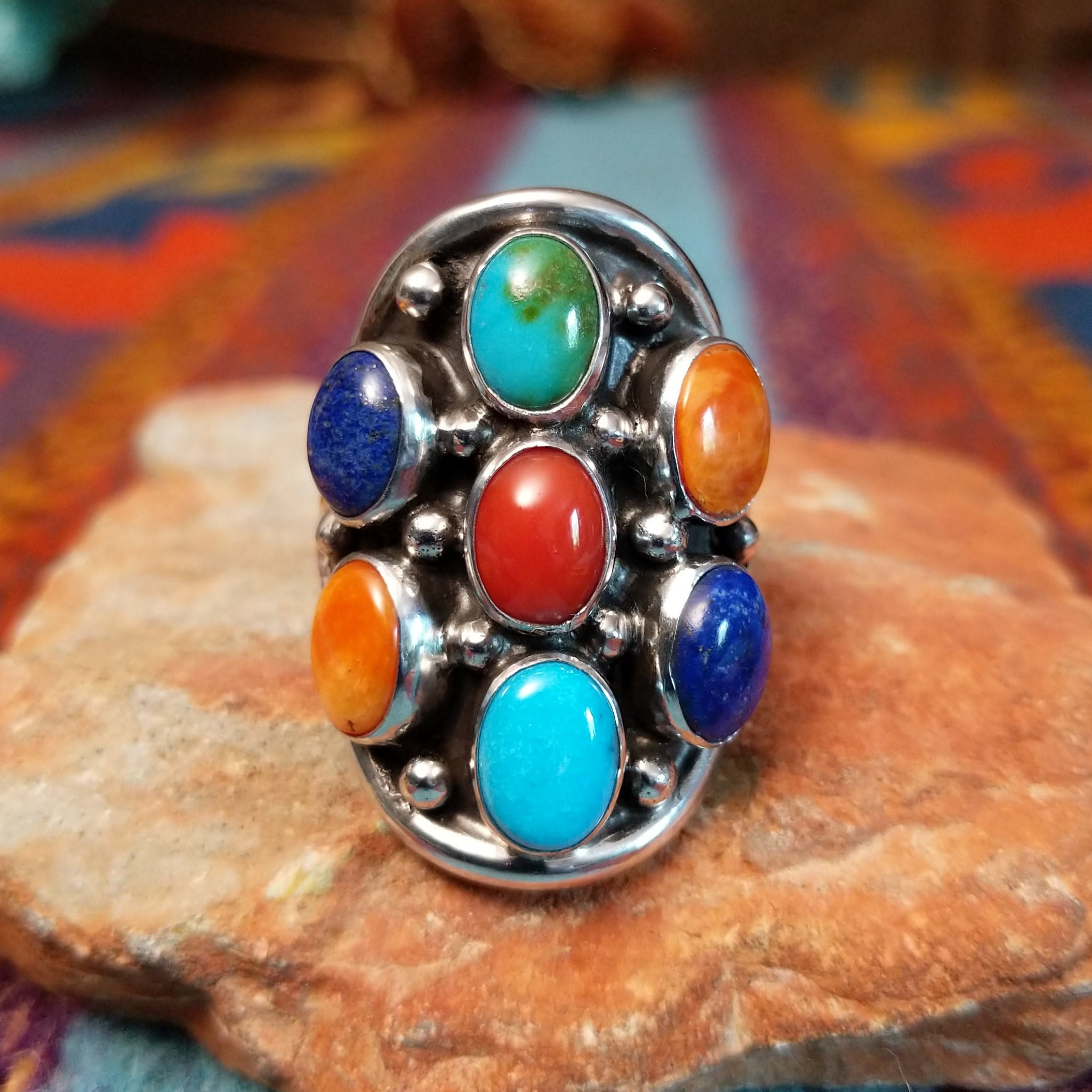 Multistone Cluster Ring by Raymond Coriz featuring turquoise, coral, lapis, and orange-toned stones set in Sterling Silver with polished silver bead accents.
