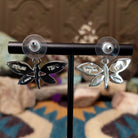 Handcrafted Navajo sterling silver dragonfly earrings by O. James featuring colorful multistone inlay wings in a polished silver dangle design; artisan and Sterling Silver stamp.
