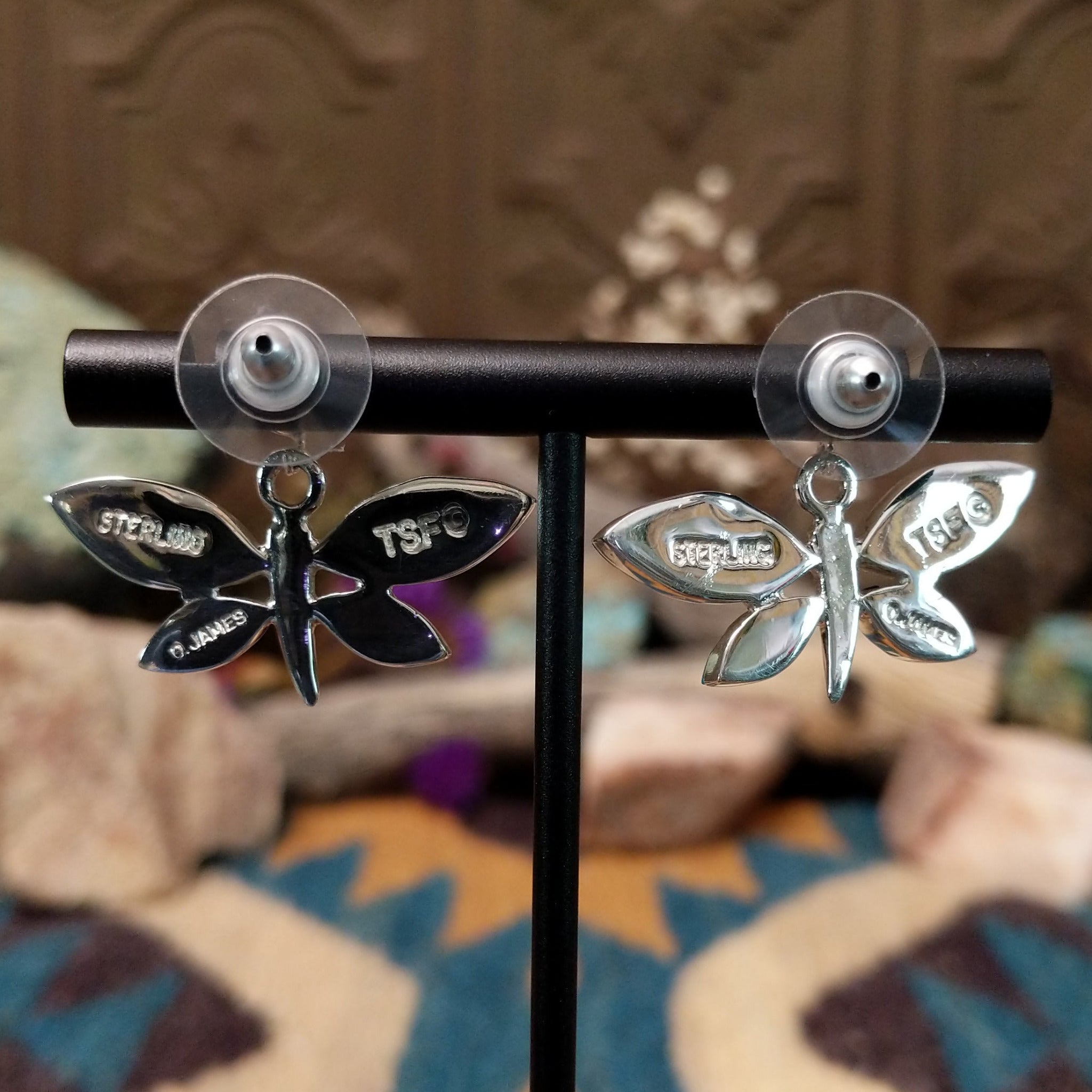 Handcrafted Navajo sterling silver dragonfly earrings by O. James featuring colorful multistone inlay wings in a polished silver dangle design; artisan and Sterling Silver stamp.