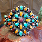Sterling silver cuff bracelet with multistone assortment set in various bezels, framed by twisted rope and dotted accents.