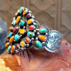 Sterling silver cuff bracelet with multistone assortment set in various bezels, framed by twisted rope and dotted accents.