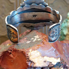 Sterling silver cuff bracelet with multistone assortment set in various bezels, framed by twisted rope and dotted accents.
