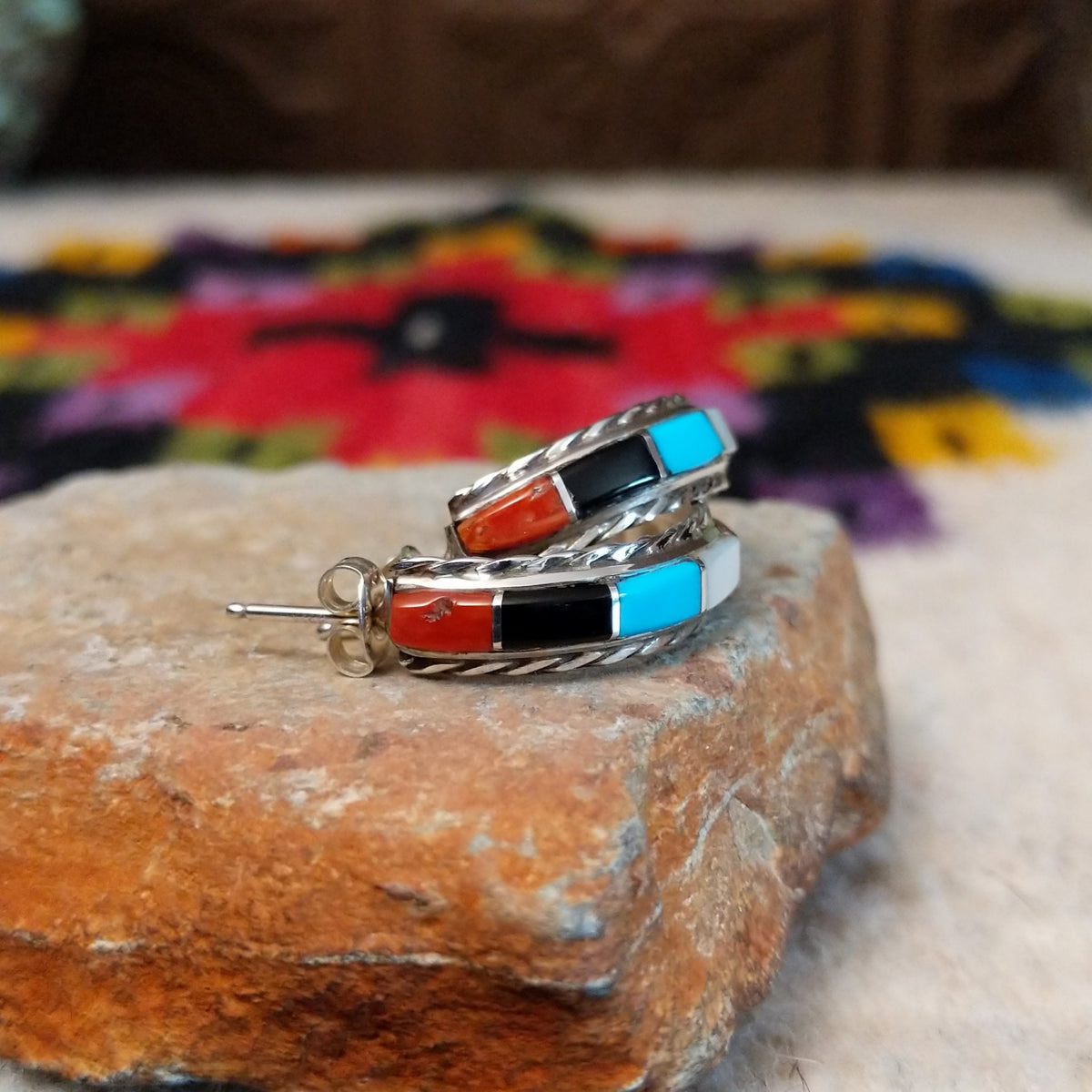 Multistone inlay hoop earrings by Malcolm Chavez with twisted silver borders.