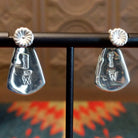 The back of the earrings features the artisan's stamped initial.