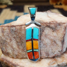 Sterling silver feather pendant with multistone inlay.