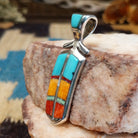 Sterling silver feather pendant with multistone inlay.