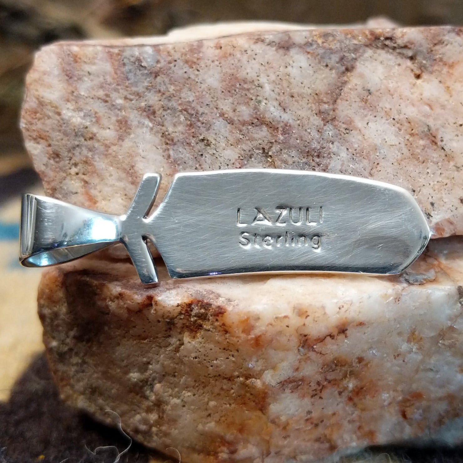Close-up of the artisan's stamped signature.