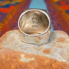 Multistone Inlay Ring by E.D. featuring a large rectangular face with geometric turquoise, blue, purple, cream, and multicolored stone inlay separated by fine silver channels; underside view.
