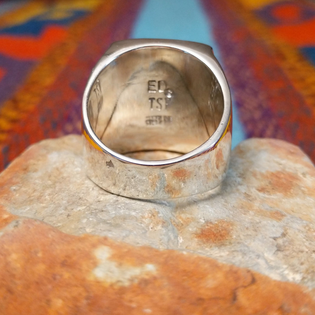 Multistone Inlay Ring by E.D. featuring a large rectangular face with geometric turquoise, blue, purple, cream, and multicolored stone inlay separated by fine silver channels; underside view.