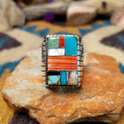 Sterling silver multistone inlay ring by Rex Abeita featuring turquoise, red coral, mother-of-pearl, black onyx, and a geometric mosaic design.