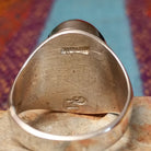 Multistone Inlay Ring by Wilbert Grey featuring an oval geometric design of orange, turquoise, and deep blue stones separated by fine silver channels in a polished silver setting; artisan and Sterling Silver stamp.