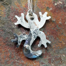 Handcrafted sterling silver multistone lizard pin and pendant by Tamara Pinto, featuring traditional Zuni inlay in a colorful lizard design; artisan signature.