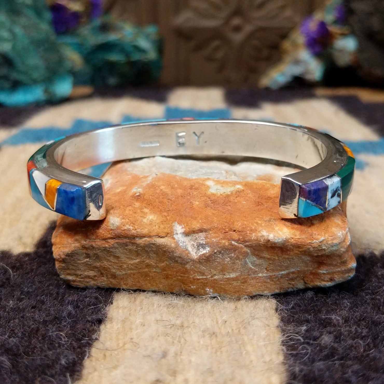 Multistone Medley cuff by Elsie Yellowhorse, featuring a colorful arrangement of natural stones set in handcrafted Southwestern-inspired metalwork.  Underside view.