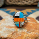 Handcrafted sterling silver oval inlay ring by Rex Abeita in a colorful geometric mosaic set in a polished silver bezel.