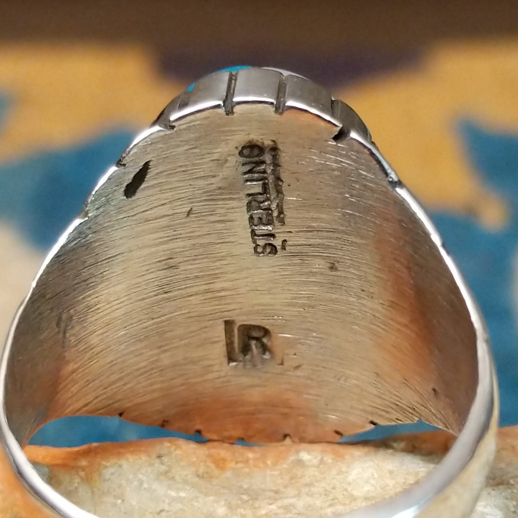 Handcrafted sterling silver oval inlay ring by Rex Abeita in a colorful geometric mosaic set in a polished silver bezel; artisan and Sterling Silver stamp.