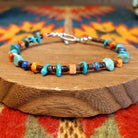 Sterling silver bracelet with beaded turquoise, orange spiny oyster shell, and pen shell.