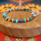 Sterling silver bracelet with beaded turquoise, orange spiny oyster shell, and pen shell.