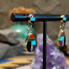 14kt gold Calvin Begay earrings with multistone teardrop inlay and oval tops.