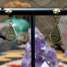 Close up of artist's stamped signature and 14K indicating 14 karat gold construction.