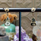 Close up of artist's stamped signature and 14K indicating 14 karat gold construction.