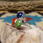 Multistone trio ring by Ann Curley, featuring blue lapis, green turquoise, and red spiny oyster shell set in a handcrafted sterling silver ring with a contemporary design.  Side view.