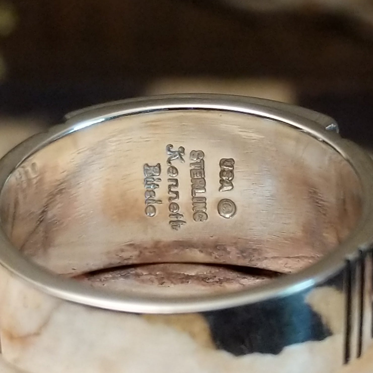 Close-up of the artisan's stamped signature.