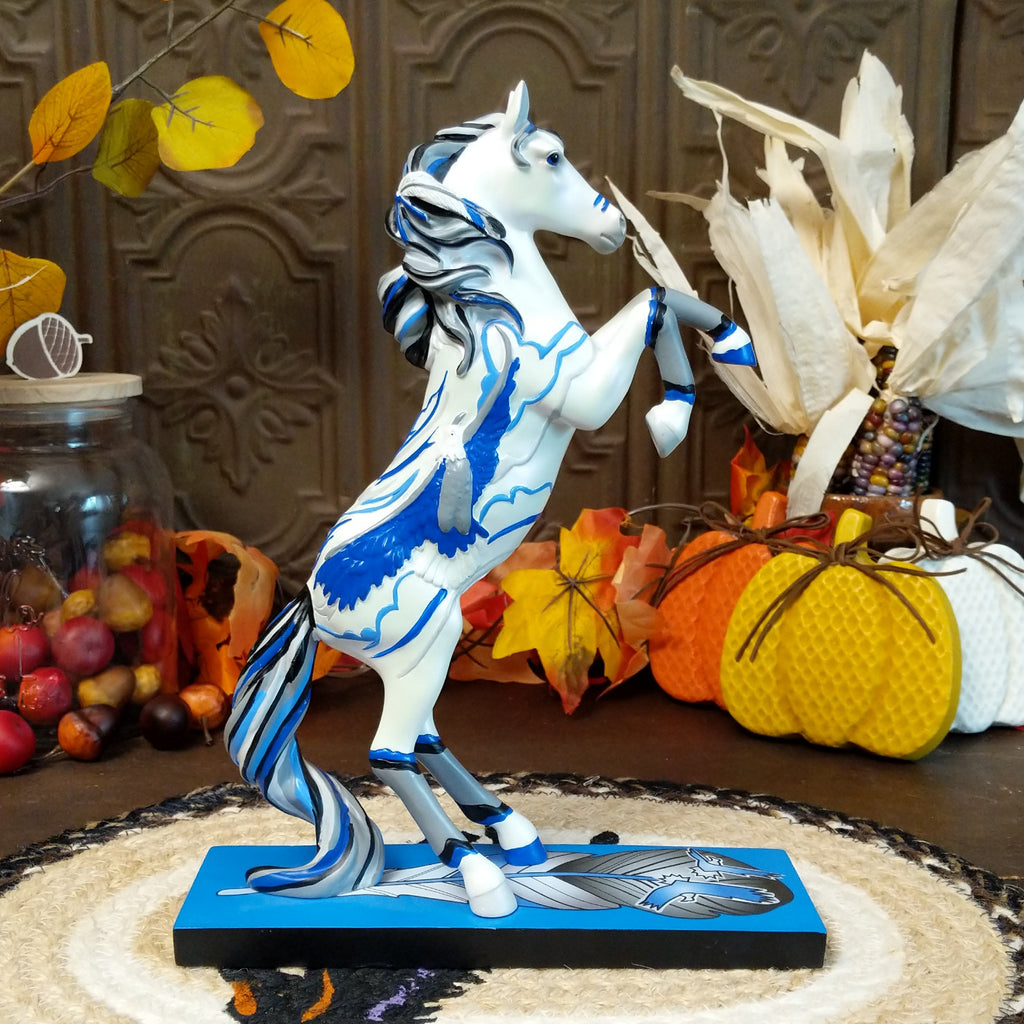Resin pony painted white with Native American motif and contrasting blue paints.