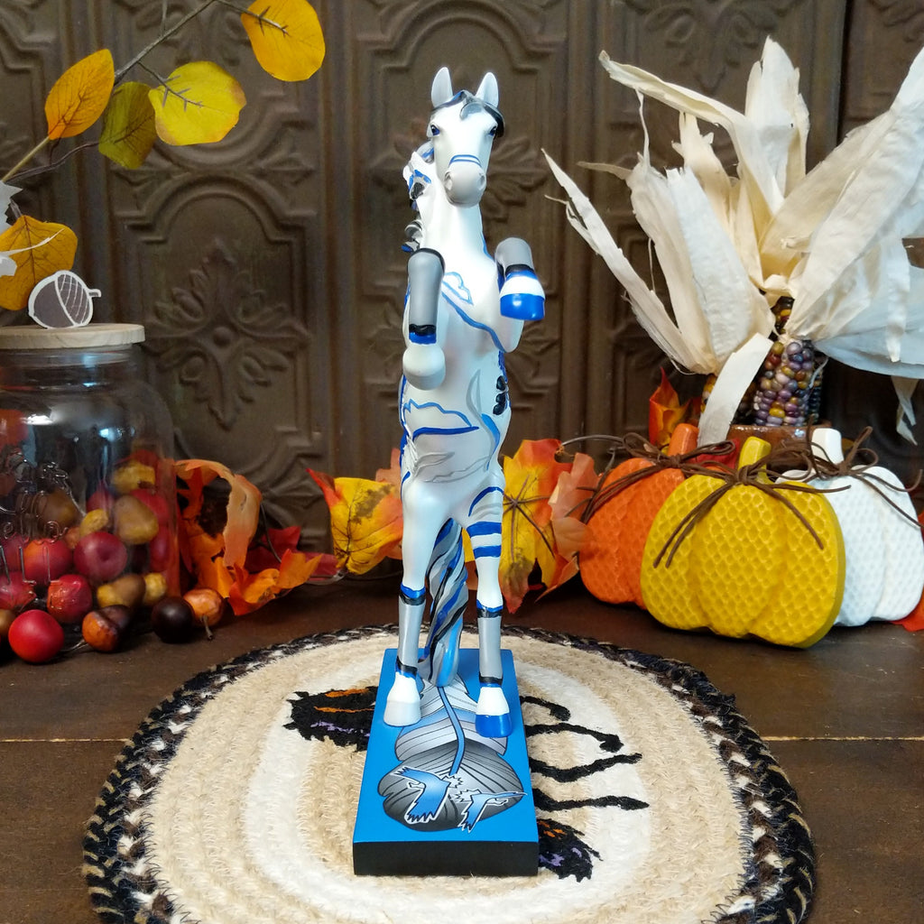Resin pony painted white with Native American motif and contrasting blue paints.