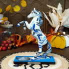 Resin pony painted white with Native American motif and contrasting blue paints.
