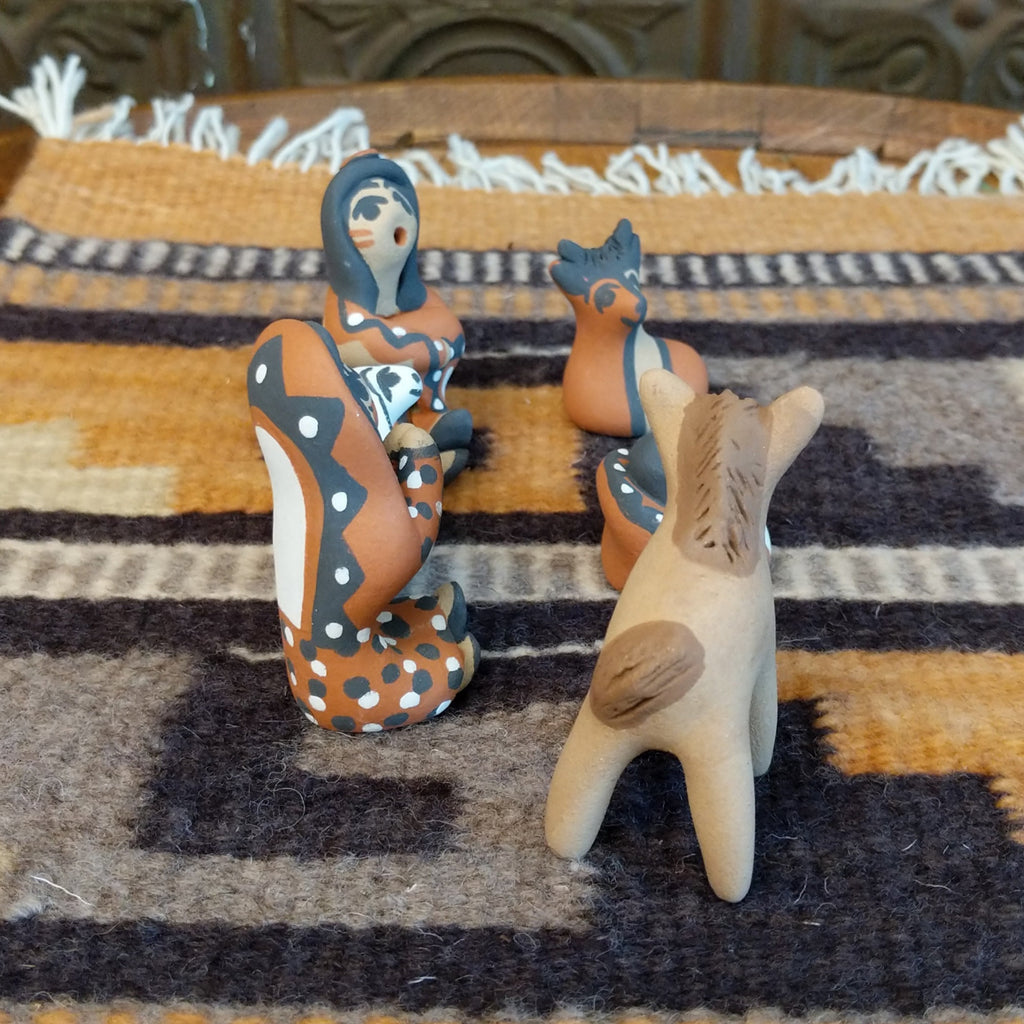 Clay sculpted into a nativity scene and painted in the colors brown, black, white, and terracotta.