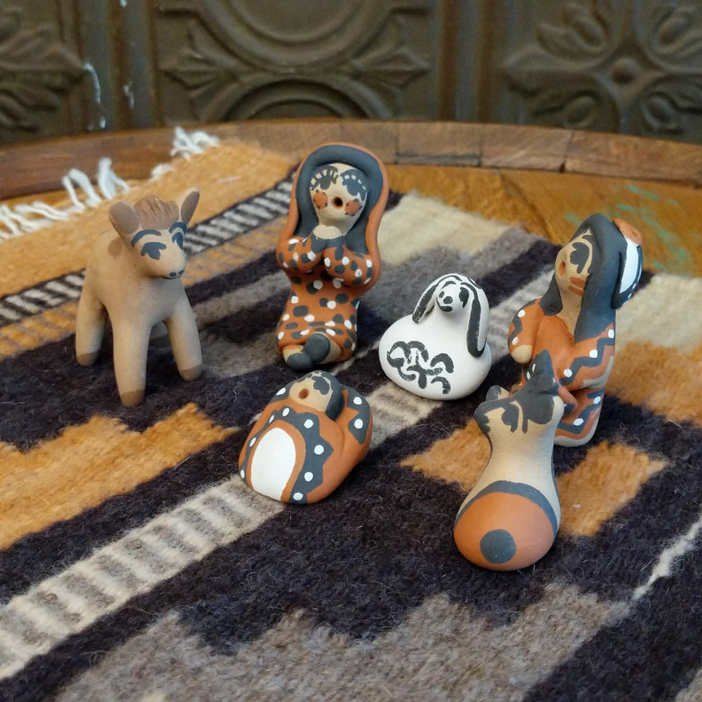 Clay sculpted into a nativity scene and painted in the colors brown, black, white, and terracotta.