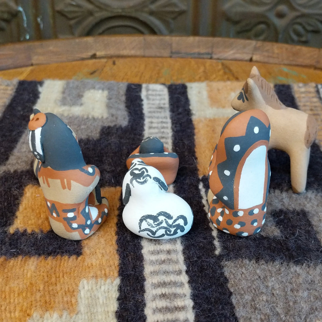 Clay sculpted into a nativity scene and painted in the colors brown, black, white, and terracotta.
