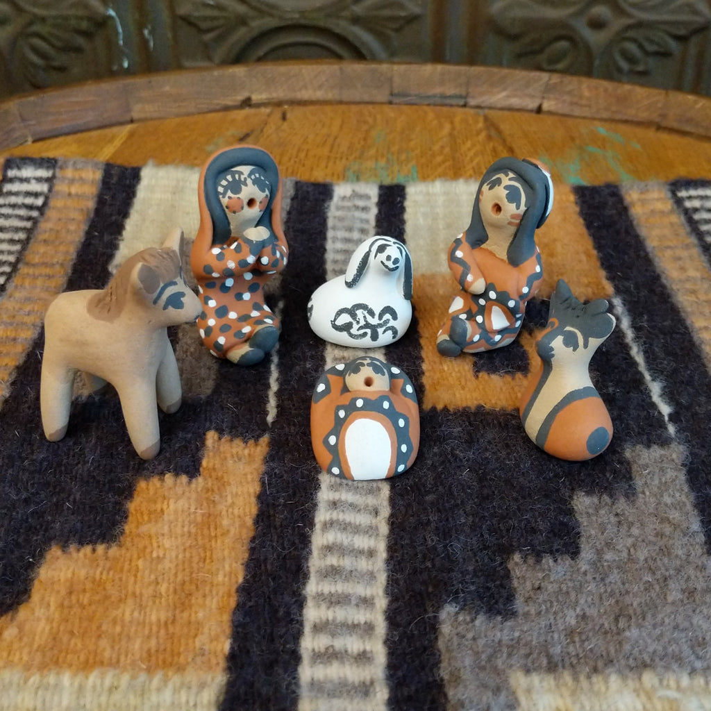 Clay sculpted into a nativity scene and painted in the colors brown, black, white, and terracotta.