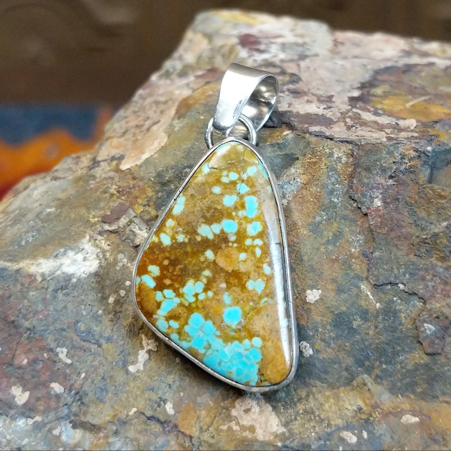 Sterling silver triangular pendant with #8 turquoise set in the bezel.