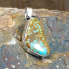 Sterling silver triangular pendant with #8 turquoise set in the bezel.