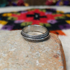 Refined Navajo Black Onyx Feather Ring featuring a polished oval black onyx stone set in sterling silver with detailed feather-inspired silverwork along the band; underside view.