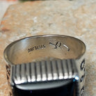Navajo black onyx ring by J.P.J. with stamped silver band. Close up of the artist's stamped signature.