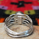 Navajo silver ring with polished black onyx and a multi-strand wavy band. Close up of the artist's stamped signature.