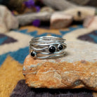 Navajo sterling silver multi-strand ring with polished Black Onyx cabochons.