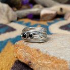 Navajo sterling silver multi-strand ring with polished Black Onyx cabochons; side view.