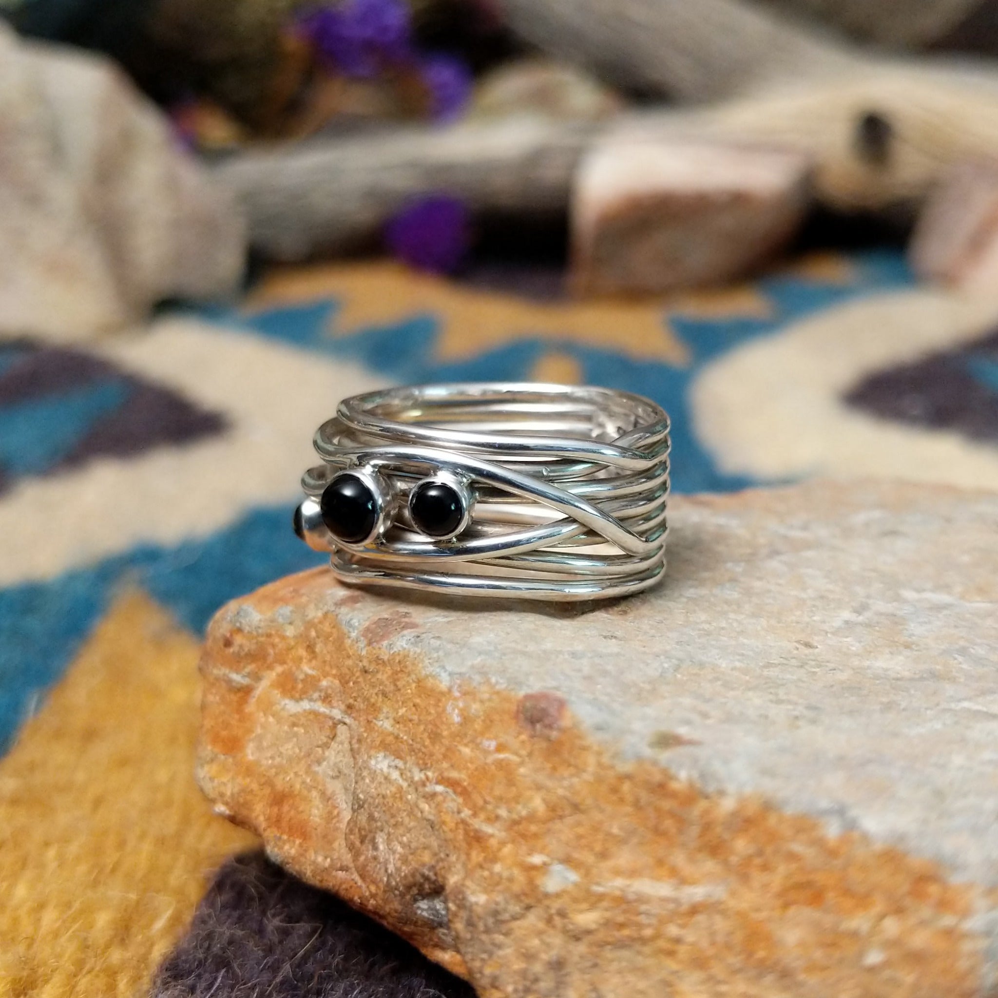 Navajo sterling silver multi-strand ring with polished Black Onyx cabochons; side view.