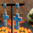 Sterling silver earrings with blue manmade opal inlaid in the cross settings.