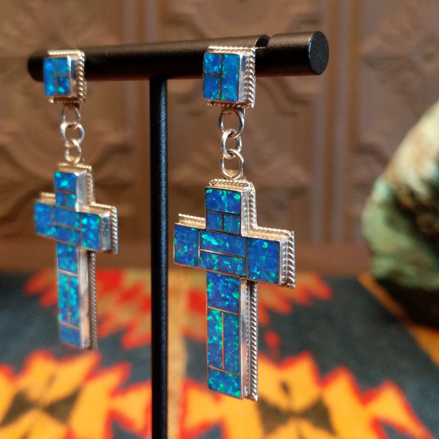 Sterling silver earrings with blue manmade opal inlaid in the cross settings.