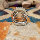 Navajo sterling silver ring with an oval Charoite stone in shades of purple with natural black inclusions; underside view.