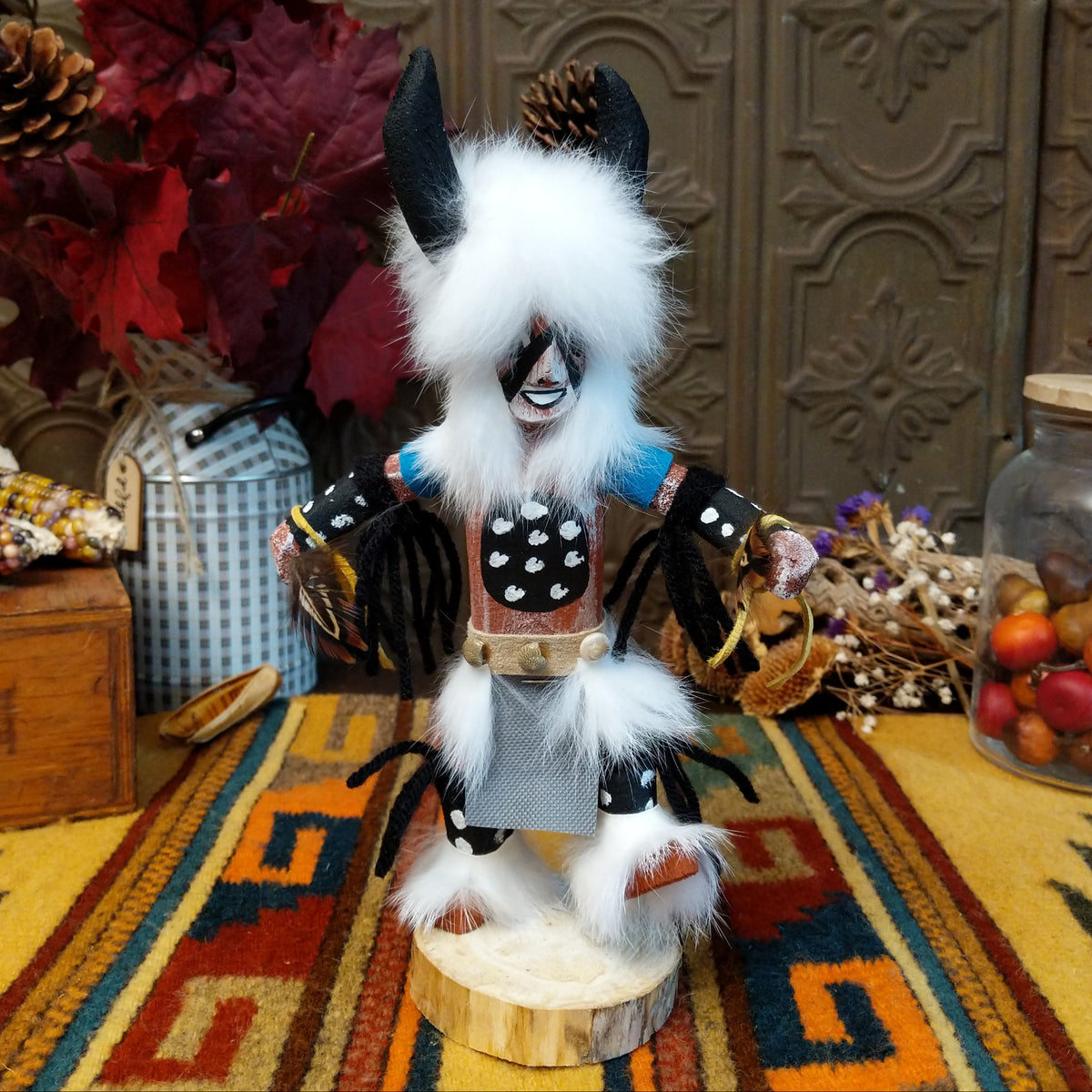Navajo Buffalo Dancer Kachina doll with black horns, thick white fur, black-and-white painted details, and blue shoulder accents.