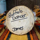 Underside of Navajo Buffalo Dancer Kachina doll base with handwritten figure name and artist surname.