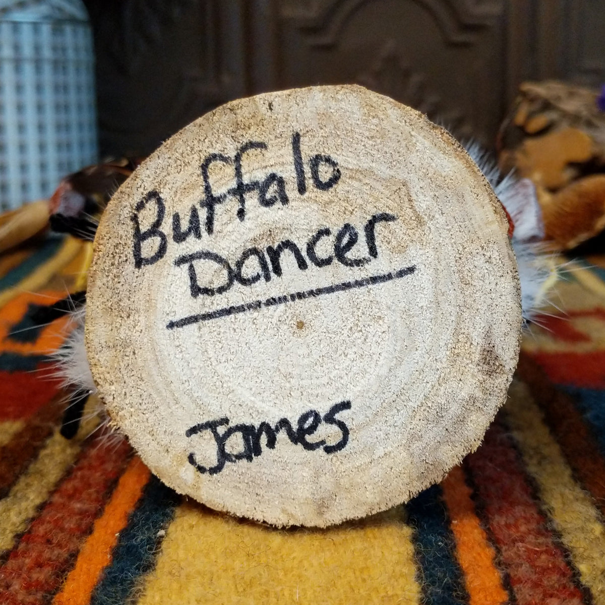 Underside of Navajo Buffalo Dancer Kachina doll base with handwritten figure name and artist surname.