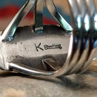 Close-up of the artisan's stamped signature.